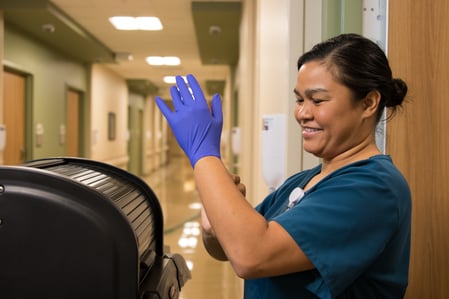 EVS housekeeper putting on gloves