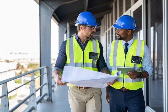 construction management_website_0001_construction management-our approach-two people looking at plans