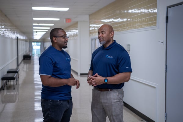 Director talking with janitorial staff